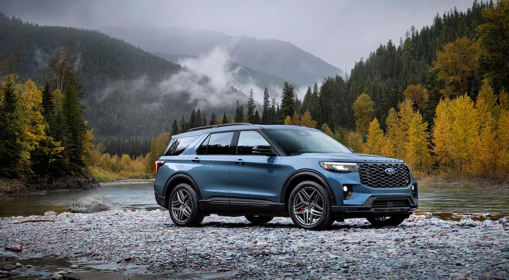 A blue 2025 Ford Explorer ST is shown from the side.