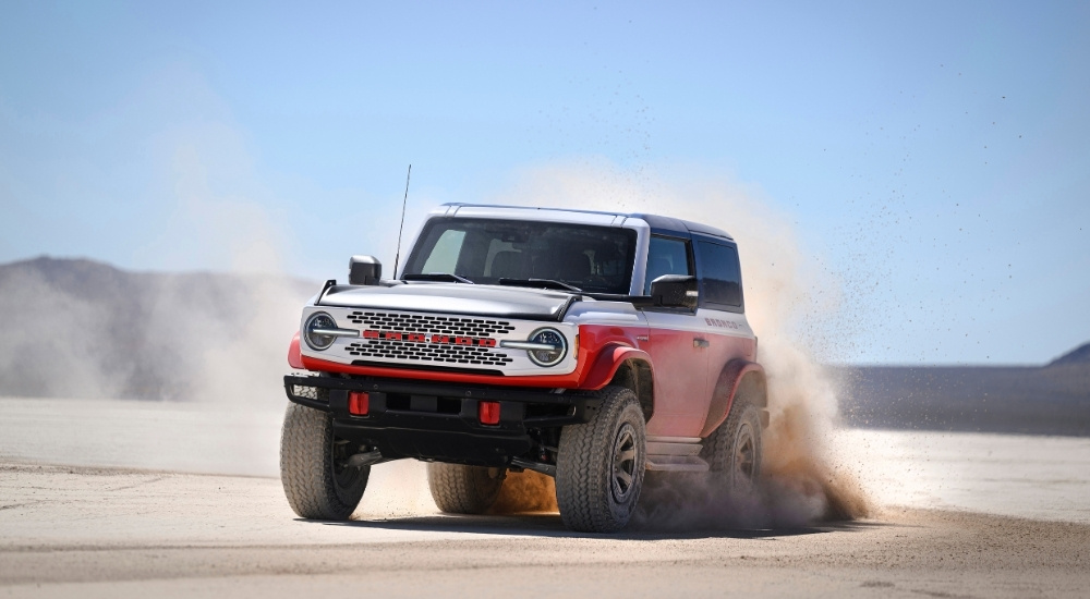 A red 2025 Ford Bronco Stroppe Edition off-roading.