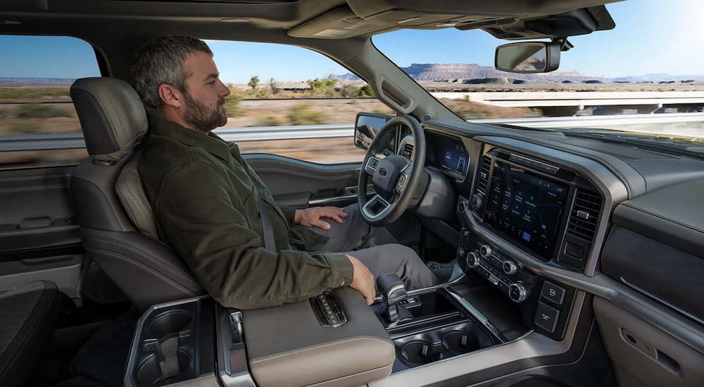 Man using BlueCruise in a 2025 Ford F-150 XLT at a Ford dealer near Woodbury.