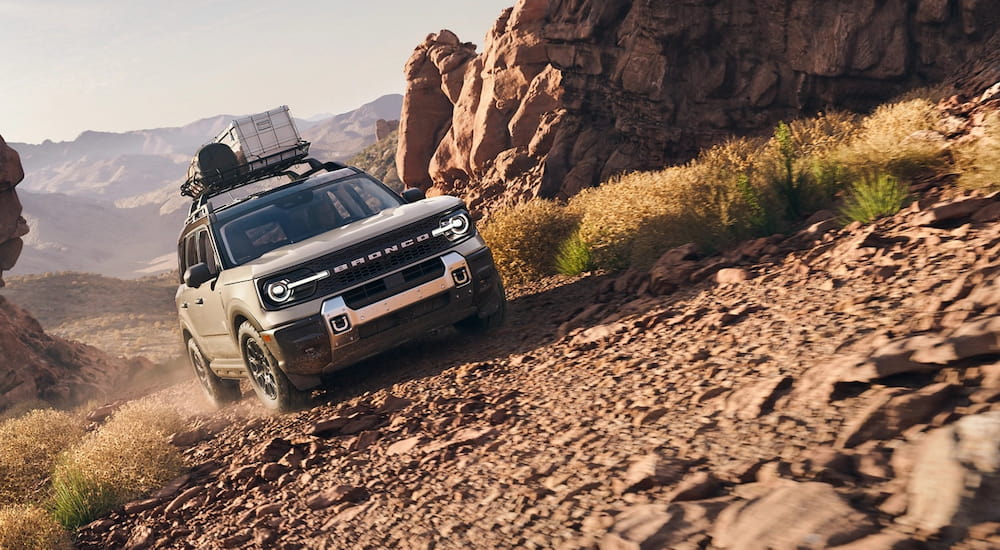 Tan 2025 Ford Bronco Sport driving up a hill.