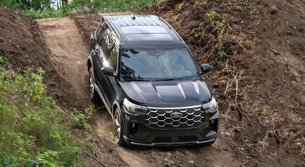 A black 2025 Ford Explorer for sale driving off-road.