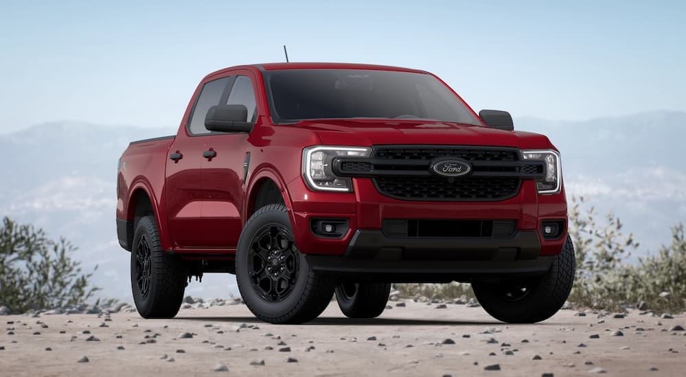 A red 2025 Ford Ranger parked off-road.