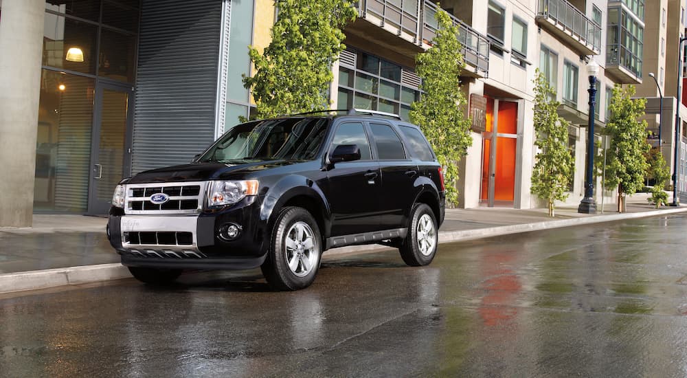 A black 2012 Ford Escape parked in a city