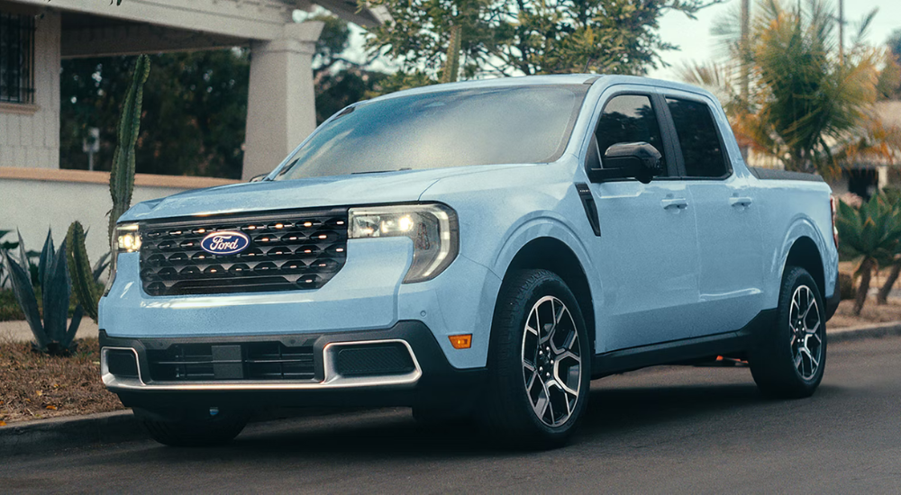 Blue 2026 Ford Maverick parked on a street in front of a house
