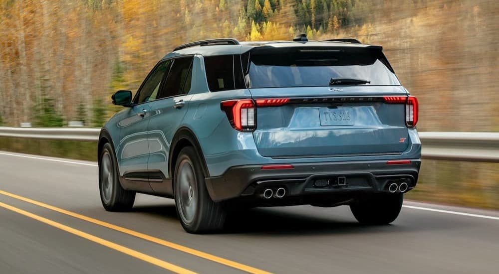 A blue 2026 Ford Explorer driving on a highway.