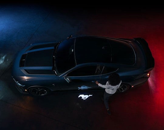 2024 Ford Mustang® Dark Horse™ model with a driver approaching the vehicle | Lupient Ford in Baldwin WI