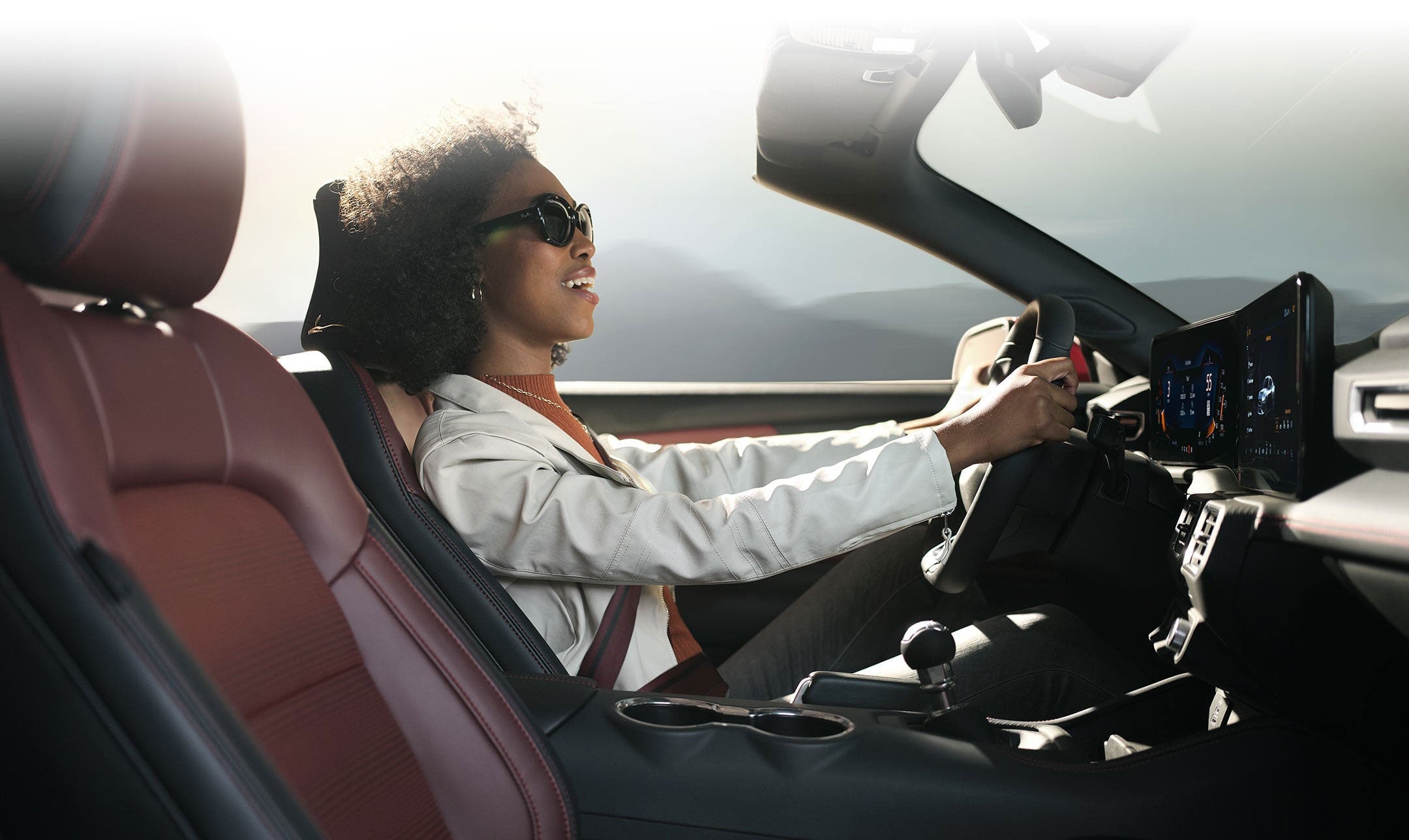 Person sitting in the driver’s seat of a 2024 Ford Mustang® convertible | Lupient Ford in Baldwin WI
