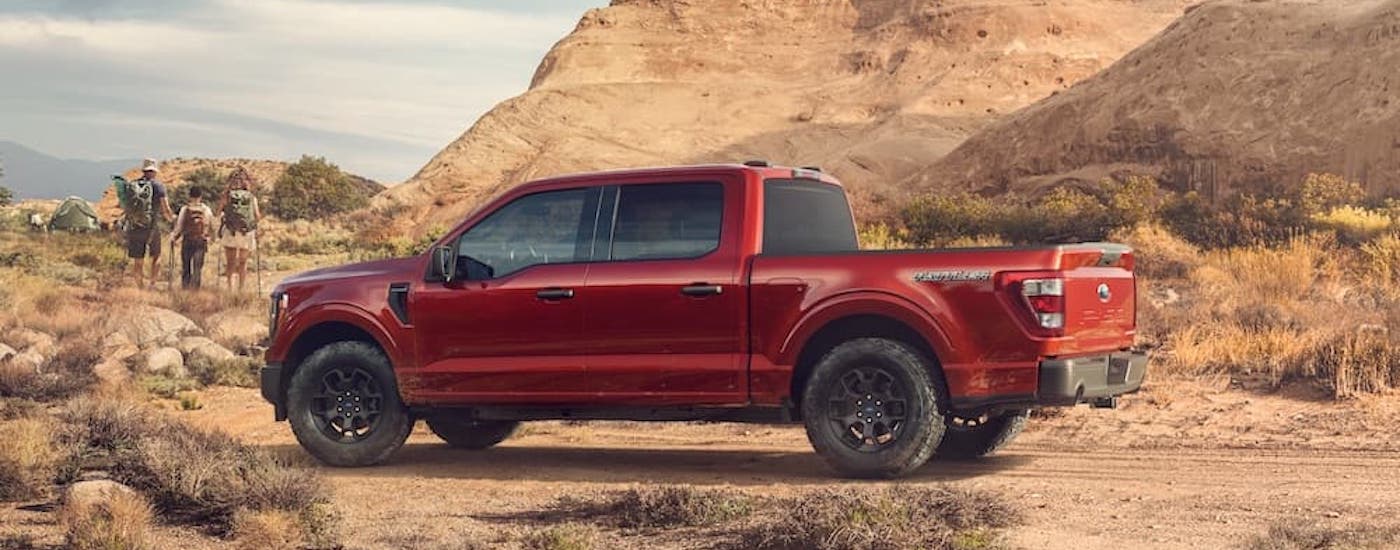 A red 2023 Ford F-150 Rattler is shown from the side.