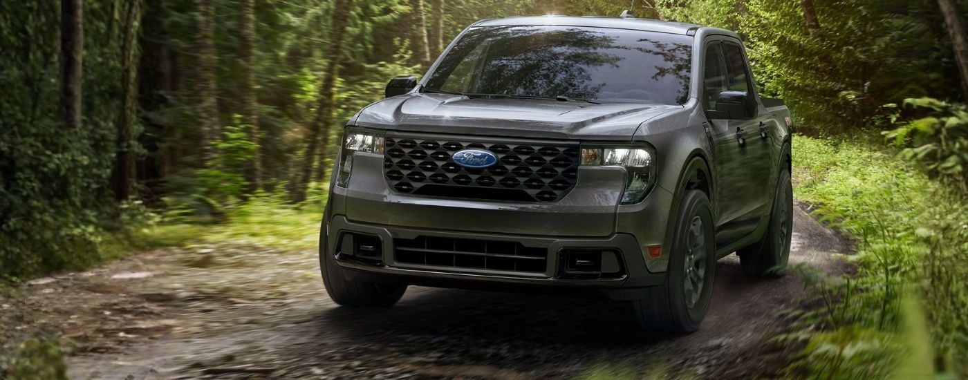 Grey 2026 Ford Maverick driving on a dirt trail