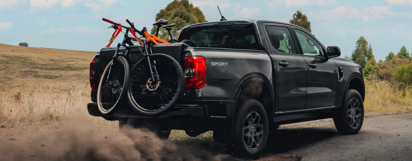 Black 2026 Ford Ranger Sport hauling a pair of bikes