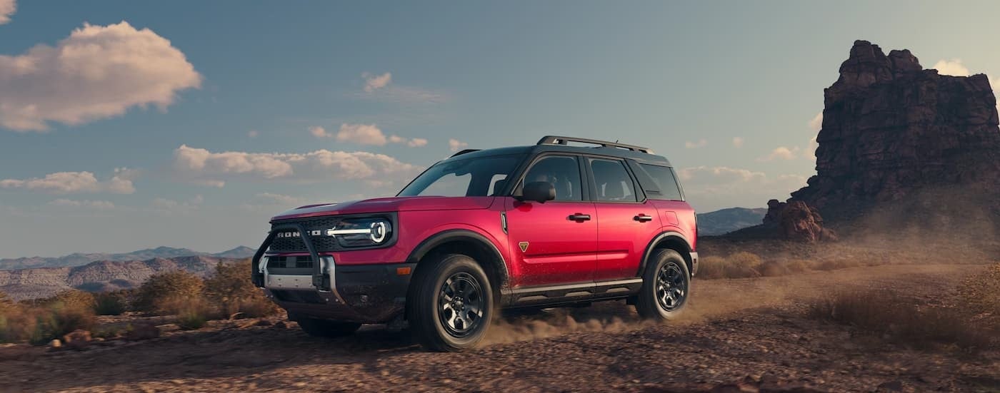 A red 2025 Ford Bronco Sport Badlands driving off-road.